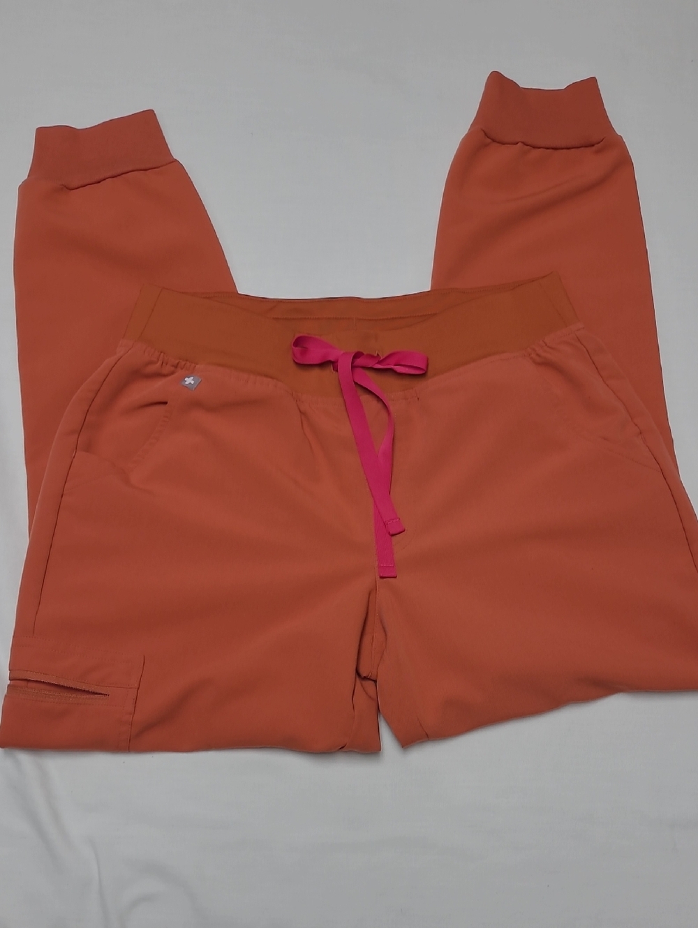 Figs Zamora Technical Collection Rust Orange jogger scrub pants with magenta tie